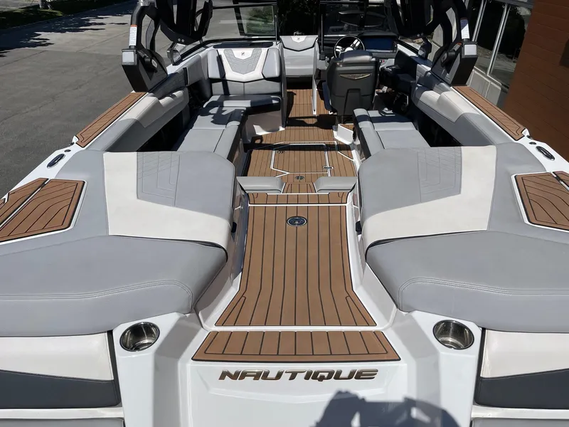 Slide: The Image of 2021 Nautique Super Air Nautique G25 interior with luxurious seating and sleek design. - 4