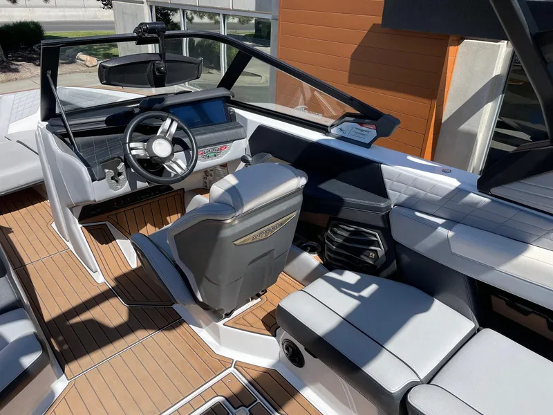 Slide: The Image of Interior of 2021 Nautique Super Air Nautique G25 boat with modern dashboard and seating. - 6