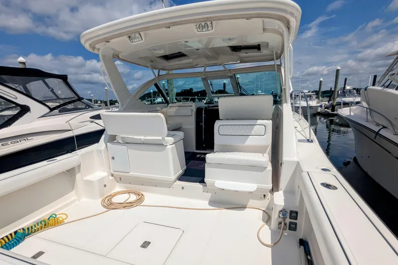 Slide: The Image of 2005 Tiara Yachts 3200 Open, spacious cockpit, marina setting, clear sky. - 11
