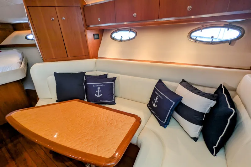 Slide: The Image of Interior of 2005 Tiara Yachts 3200 Open with cozy seating and nautical-themed cushions. - 18