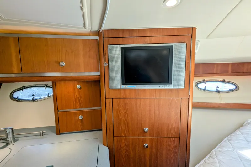Slide: The Image of 2005 Tiara Yachts 3200 Open interior with wood cabinetry and built-in TV. - 20