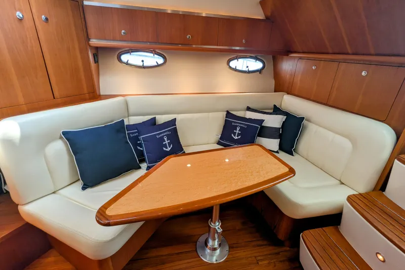 Slide: The Image of Luxurious 2005 Tiara Yachts 3200 Open interior with cozy seating and nautical-themed cushions. - 22