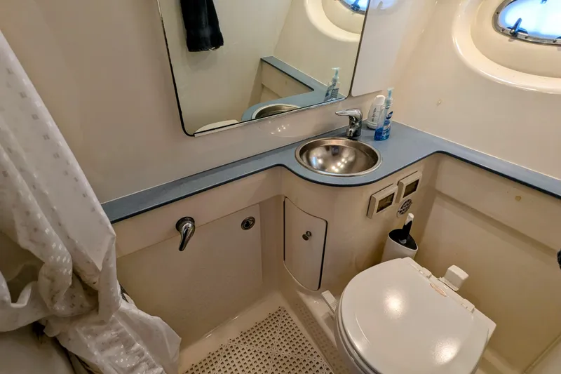 Slide: The Image of 2005 Tiara Yachts 3200 Open bathroom with sink, mirror, and toilet. - 26