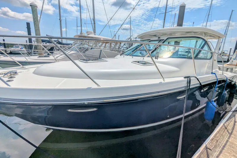 Slide: The Image of 2005 Tiara Yachts 3200 Open docked, showcasing sleek design and polished exterior. - 3