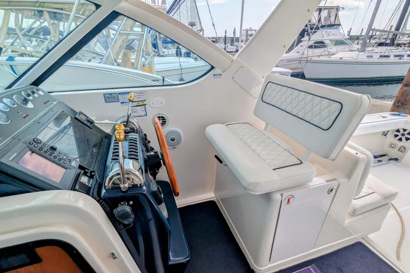 Slide: The Image of 2005 Tiara Yachts 3200 Open helm with luxurious seating and control panel. - 6