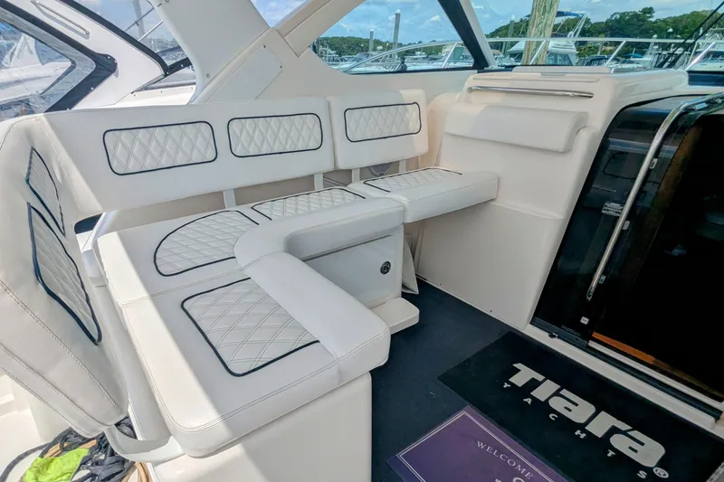 Slide: The Image of Luxurious seating area on a 2005 Tiara Yachts 3200 Open, featuring elegant white upholstery. - 8