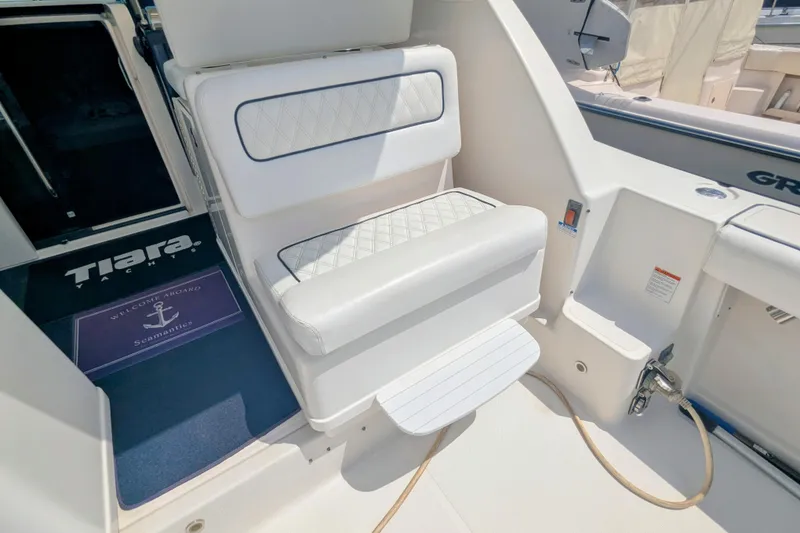 Slide: The Image of 2005 Tiara Yachts 3200 Open interior with white seating and welcome mat. - 9