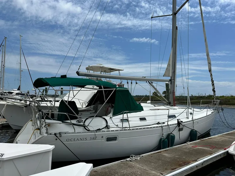 The Image of Sailboat Beneteau Oceanis 381, 1998 model, docked at marina under blue sky. - 1