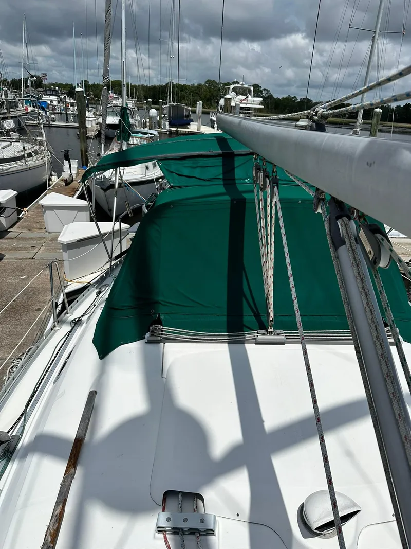 Slide: The Image of Sailboat docked at marina, Beneteau 381, 1998 model, with green canopy. - 10