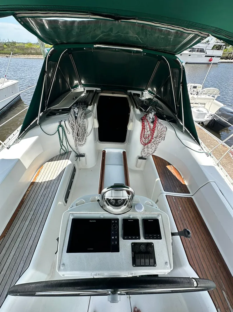 Slide: The Image of Cockpit of a 1998 Beneteau 381 sailboat with navigation equipment and seating. - 12