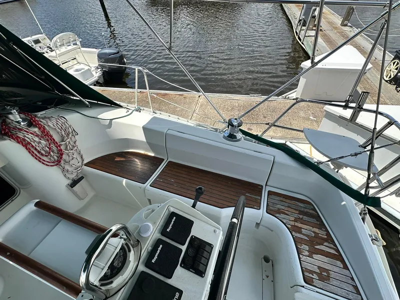 Slide: The Image of Cockpit of a 1998 Beneteau 381 sailboat with wooden accents and steering wheel. - 14