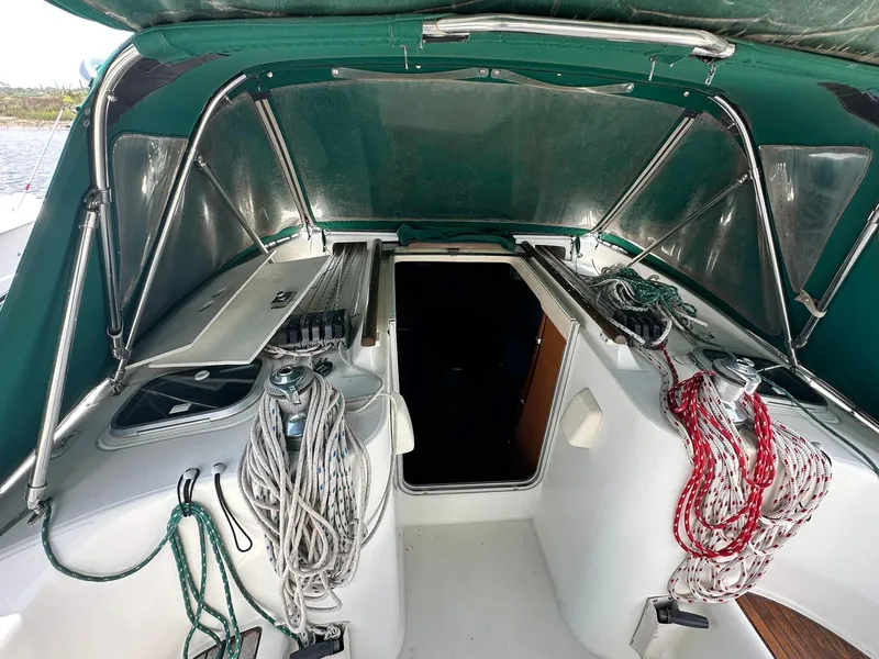 Slide: The Image of 1998 Beneteau 381 sailboat cockpit with ropes and canopy, showcasing nautical equipment. - 15