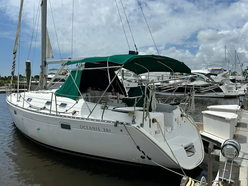Slide: The Image of 1998 Beneteau Oceanis 381 sailboat docked at marina under cloudy sky. - 3
