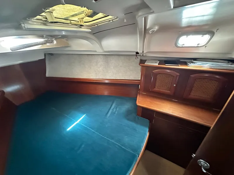 Slide: The Image of Interior cabin of a 1998 Beneteau 381 sailboat with wooden furnishings. - 36
