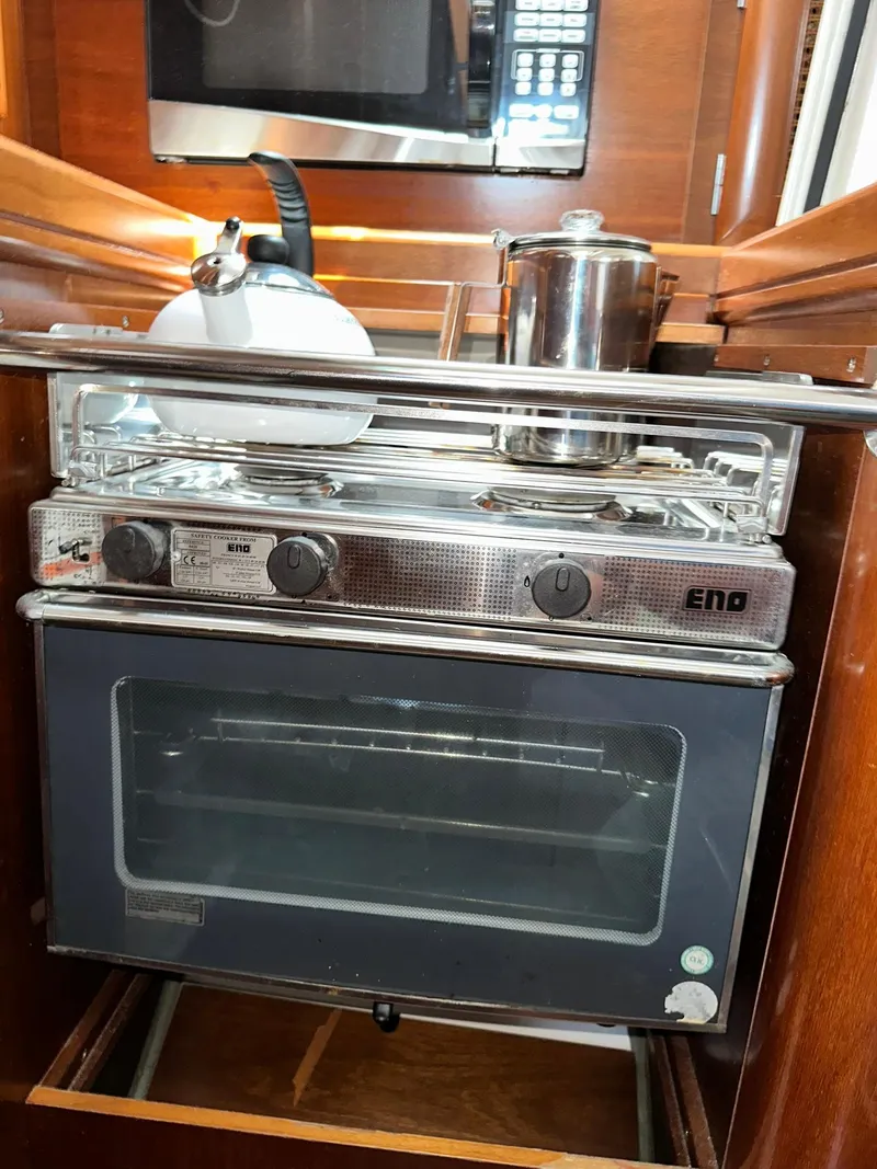 Slide: The Image of Stove and oven in 1998 Beneteau 381 yacht kitchen, featuring a kettle and pot. - 39