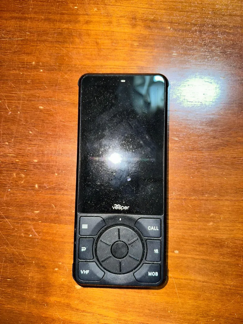 Slide: The Image of Vesper marine radio device on wooden surface, related to Beneteau 381, 1998 model. - 46