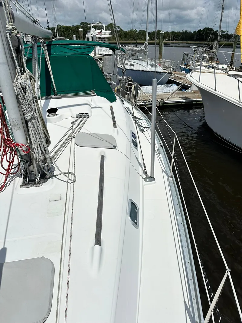 Slide: The Image of 1998 Beneteau 381 sailboat docked, featuring deck and rigging details. - 7