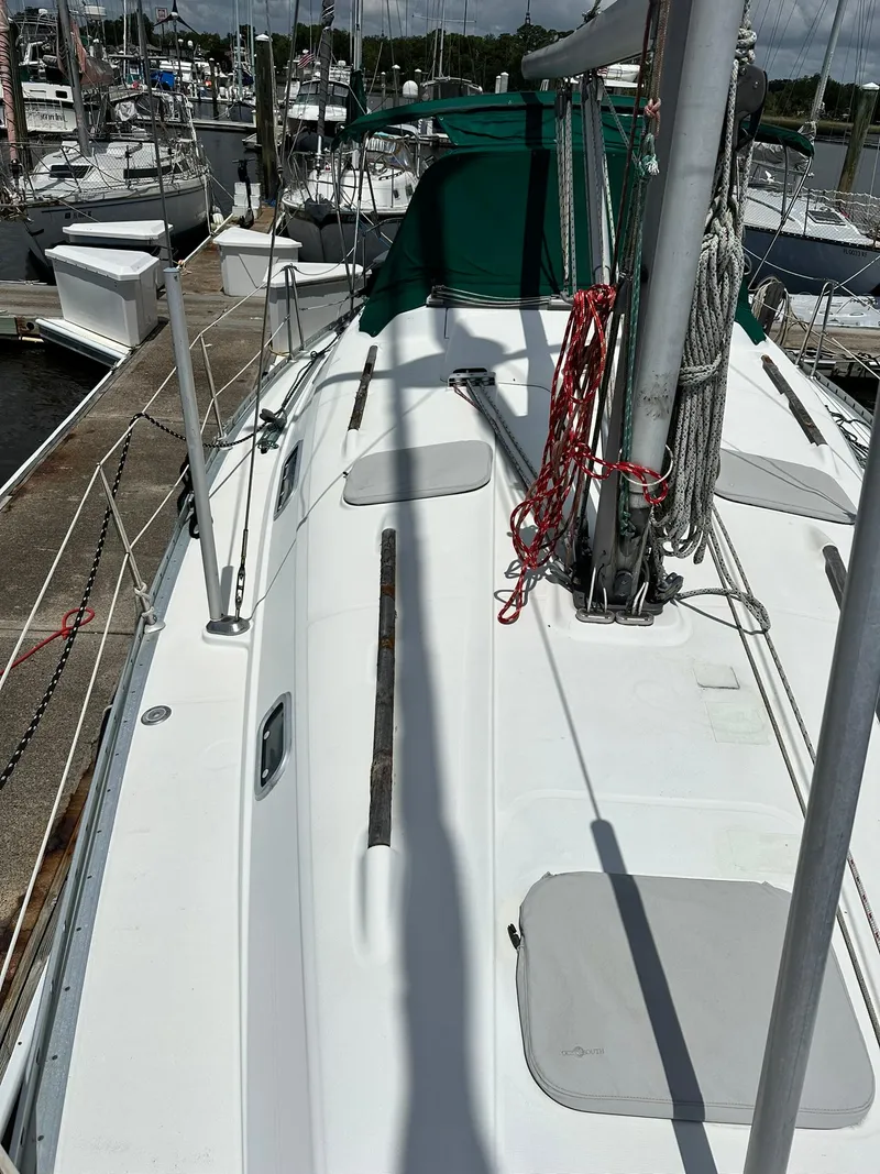 Slide: The Image of 1998 Beneteau 381 sailboat docked, featuring deck and rigging details. - 8