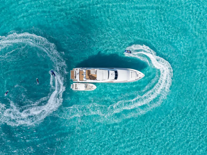 Slide: The Image of Aerial view of 2004 Ferretti Yachts 112 Custom Line with jet skis in turquoise water. - 5