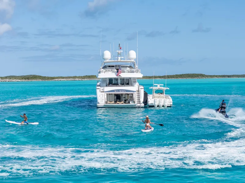 Slide: The Image of Luxurious 2004 Ferretti Yachts 112 Custom Line in turquoise waters with paddleboarders and jet ski. - 7
