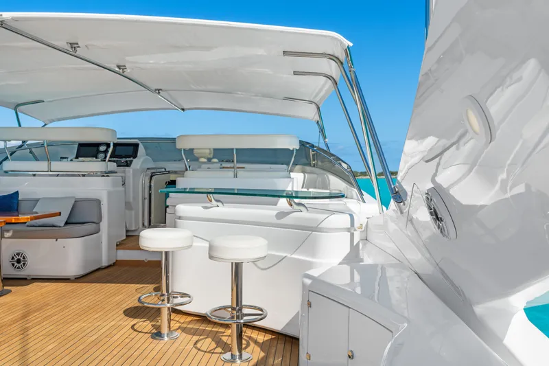 Slide: The Image of Luxurious 2004 Ferretti Yachts 112 Custom Line deck with seating and bar stools under canopy. - 11