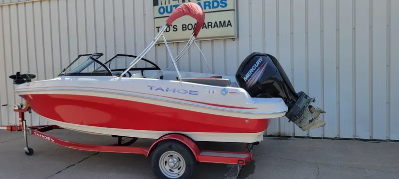 Slide: The Image of 2016 Tahoe 450 TF boat with red hull and Mercury outboard motor. - 11
