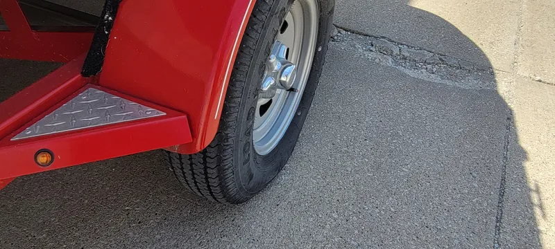 Slide: The Image of Red trailer wheel of 2016 Tahoe 450 TF on concrete surface. - 13