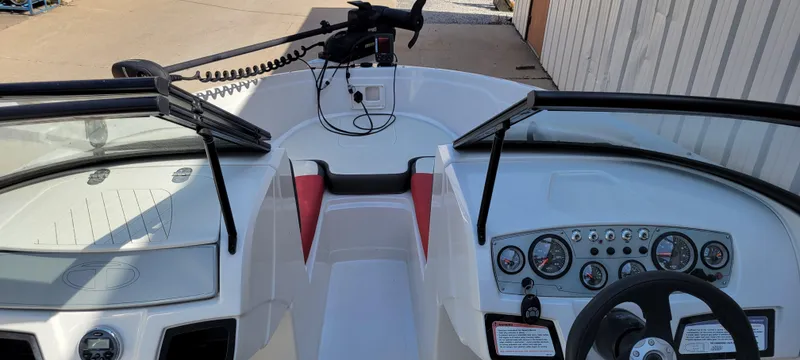 Slide: The Image of Interior view of a 2016 Tahoe 450 TF boat, featuring dashboard and steering wheel. - 23