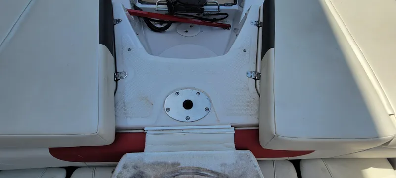 Slide: The Image of 2016 Tahoe 450 TF boat interior with white seating and storage compartment. - 29