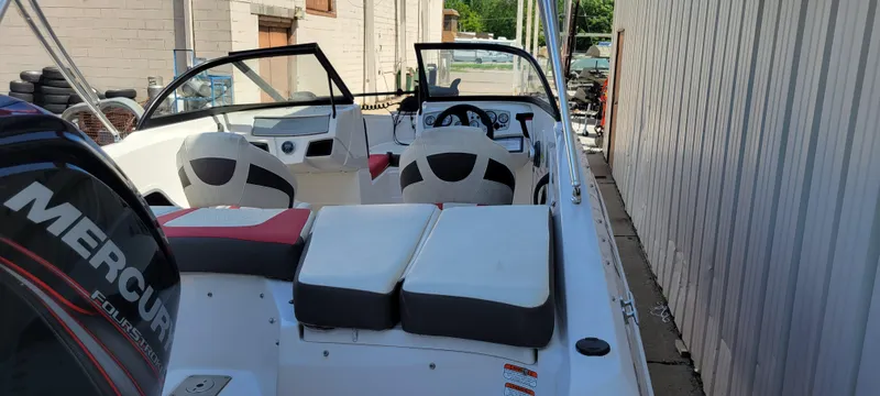 Slide: The Image of 2016 Tahoe 450 TF boat with Mercury engine, docked near a building. - 14