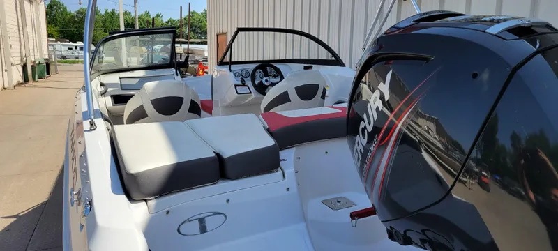 Slide: The Image of 2016 Tahoe 450 TF boat with Mercury outboard engine, featuring spacious seating and modern dashboard. - 15