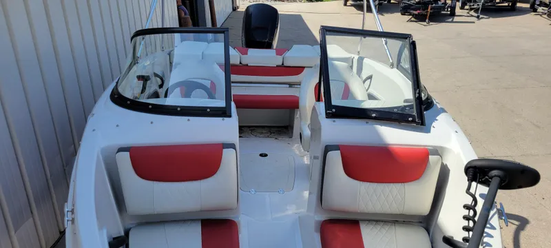 Slide: The Image of 2016 Tahoe 450 TF boat with red and white seating, open windshield, and motor. - 20