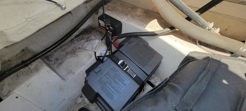 Slide: The Image of Battery compartment of a 2016 Tahoe 450 TF boat with secured battery and cables. - 31