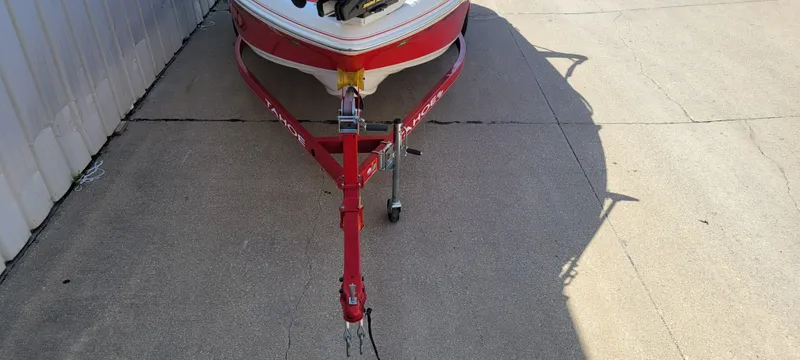 Slide: The Image of Red 2016 Tahoe 450 TF boat trailer parked on concrete surface. - 9