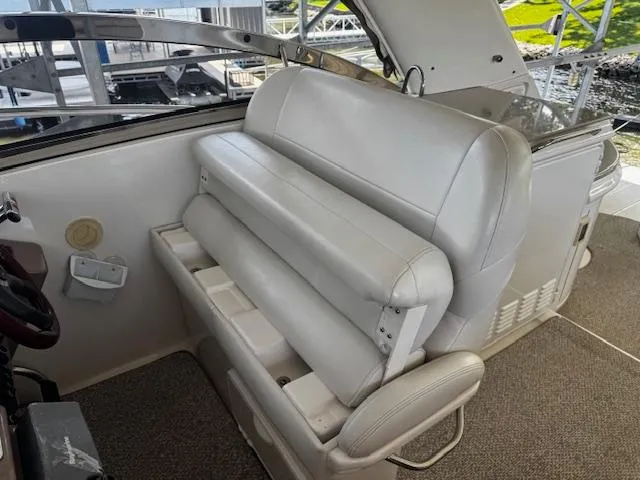 Slide: The Image of 2004 Regal Commodore 4260 boat interior with white leather seating and helm area. - 14