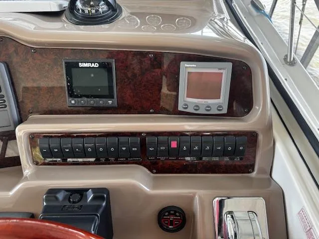 Slide: The Image of Control panel of 2004 Regal Commodore 4260 boat with Simrad and Panasonic displays. - 15