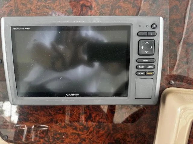 Slide: The Image of Garmin echosounder on 2004 Regal Commodore 4260 boat dashboard, featuring control buttons. - 19