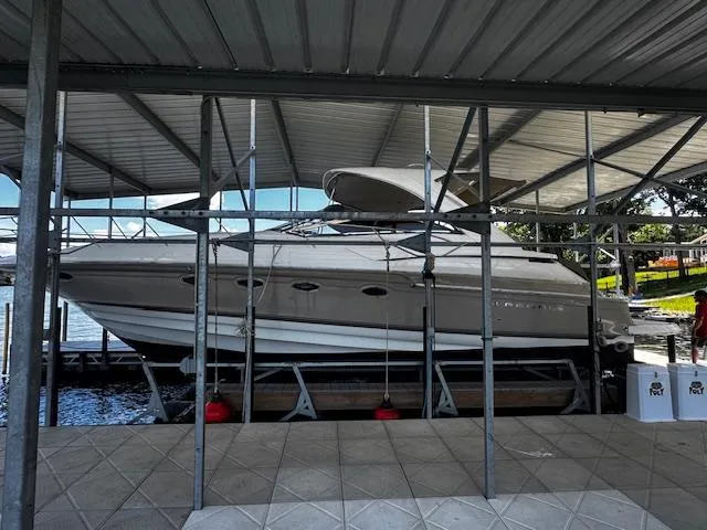 Slide: The Image of 2004 Regal Commodore 4260 yacht docked under a covered marina. - 2