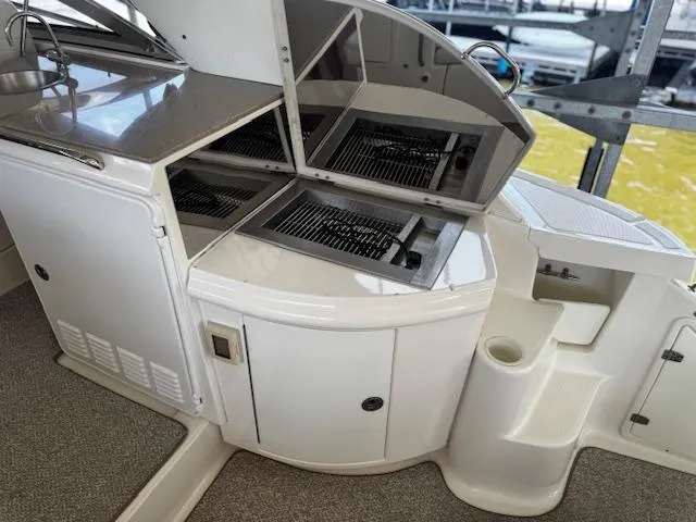 Slide: The Image of 2004 Regal Commodore 4260 yacht with open grill and storage compartments. - 30