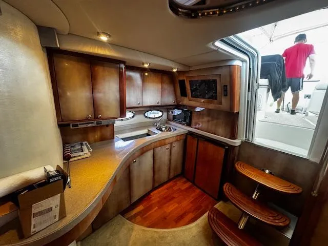 Slide: The Image of 2004 Regal Commodore 4260 yacht interior with wooden cabinetry and modern kitchen design. - 37