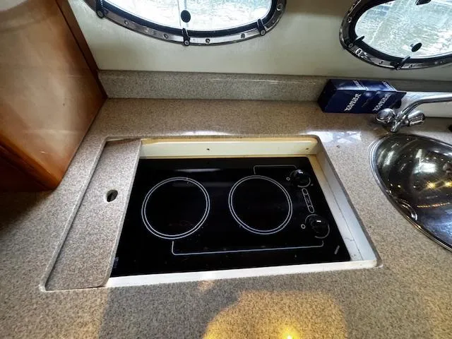 Slide: The Image of 2004 Regal Commodore 4260 yacht kitchen with electric stovetop and sink. - 40