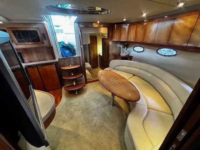 Slide: The Image of Luxurious interior of 2004 Regal Commodore 4260 yacht with elegant seating and wooden cabinetry. - 48