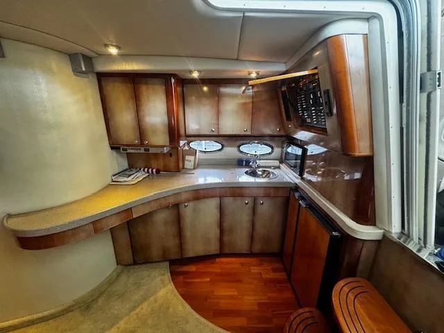 Slide: The Image of Luxurious 2004 Regal Commodore 4260 yacht interior with modern kitchen and wood finishes. - 49