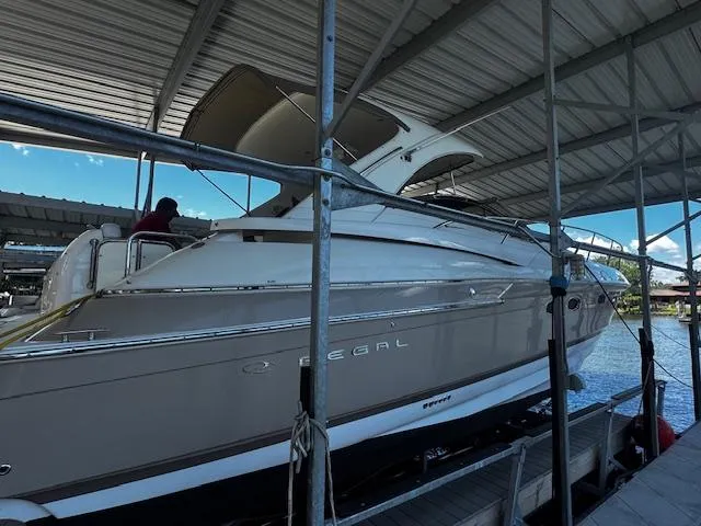 Slide: The Image of 2004 Regal Commodore 4260 yacht docked under a covered marina. - 5