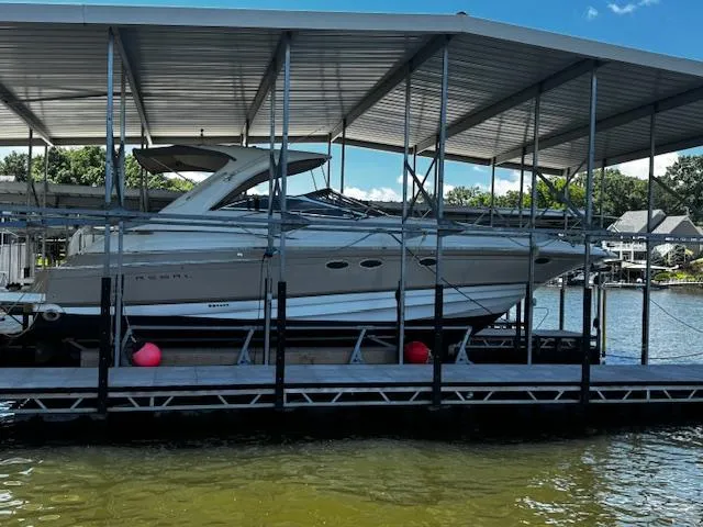 Slide: The Image of 2004 Regal Commodore 4260 yacht docked under a covered marina on a sunny day. - 6
