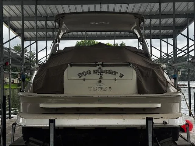 Slide: The Image of 2004 Regal Commodore 4260 boat named "Dog Biscuit" docked under a covered marina. - 8