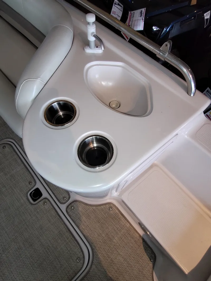 Slide: The Image of 2001 Hurricane 201GS boat interior with sink and cup holders. - 10