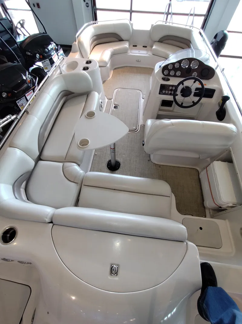 Slide: The Image of 2001 Hurricane 201GS boat interior with white seating, steering console, and table. - 12