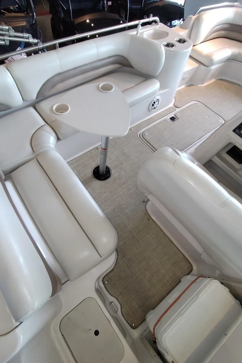 Slide: The Image of Interior of a 2001 Hurricane 201GS boat with white seating and a small table. - 13
