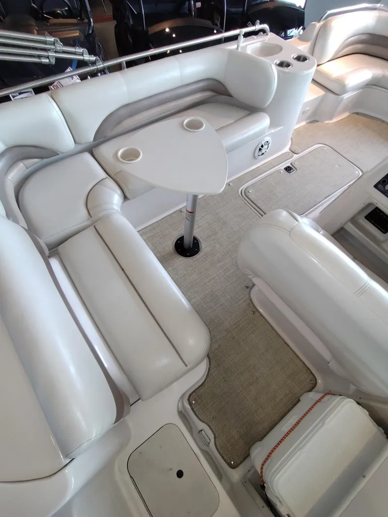 Slide: The Image of Interior of a 2001 Hurricane 201GS boat with white seating and a small table. - 14